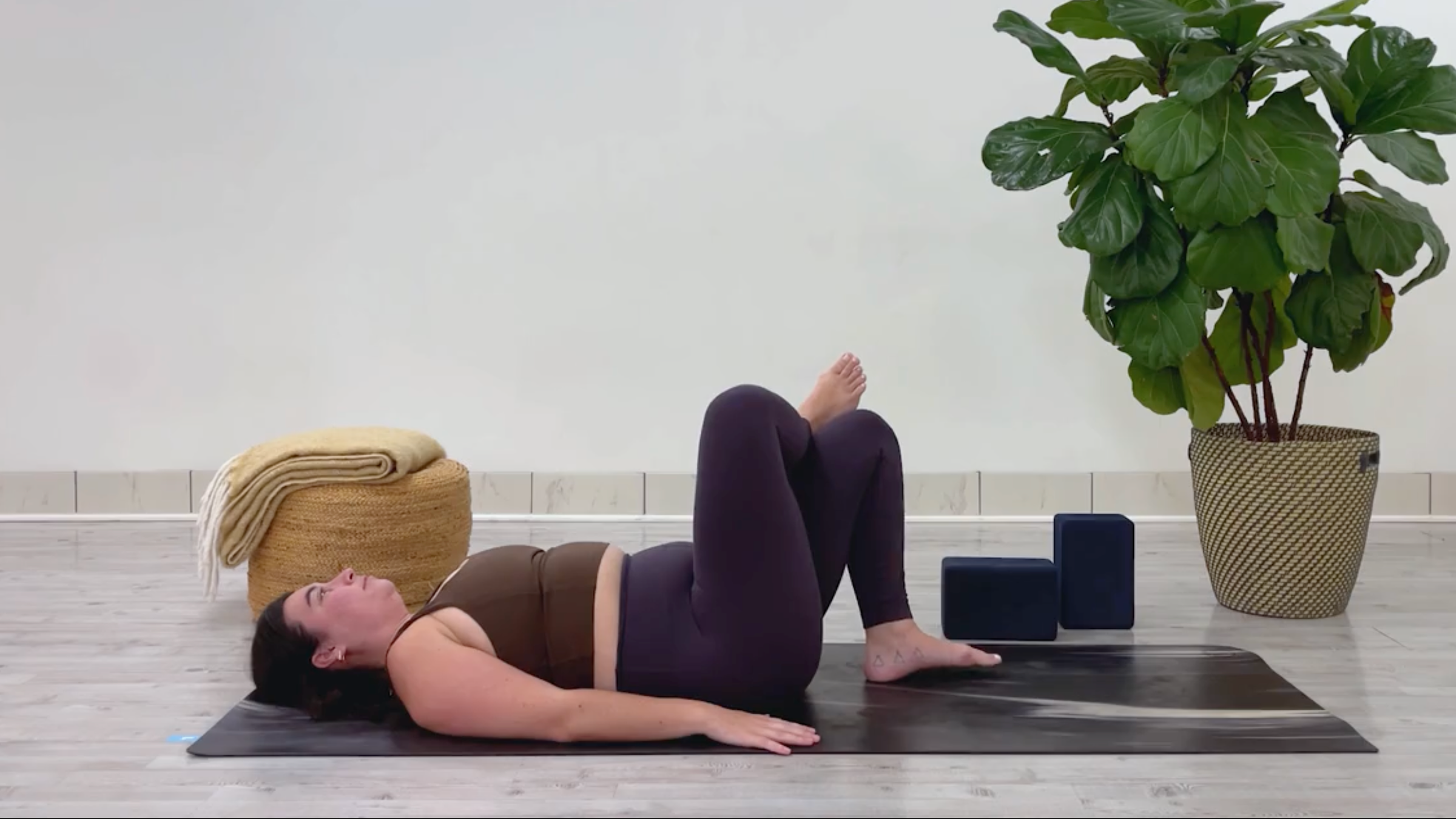 Yoga teacher Taylor Lorenz in Reclining Figure-4